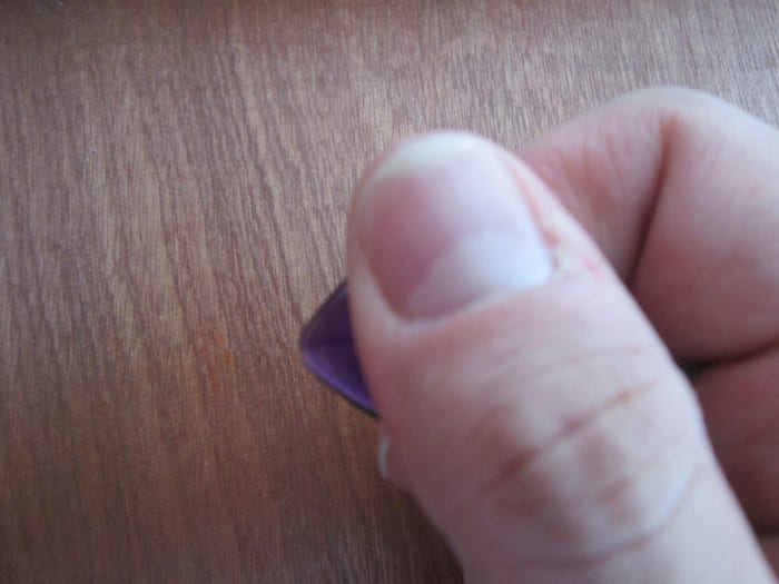 holding a guitar pick